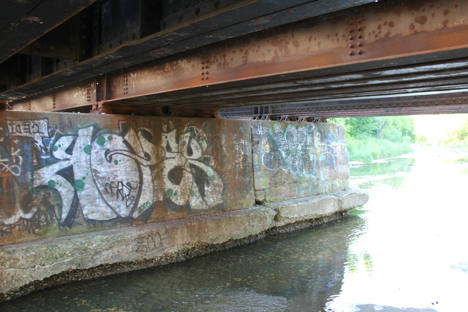 Under bridge.  Note writing on one span
